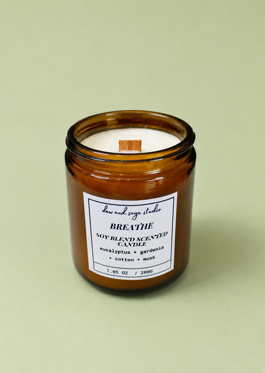 Brown candle jar with a label on a light green background