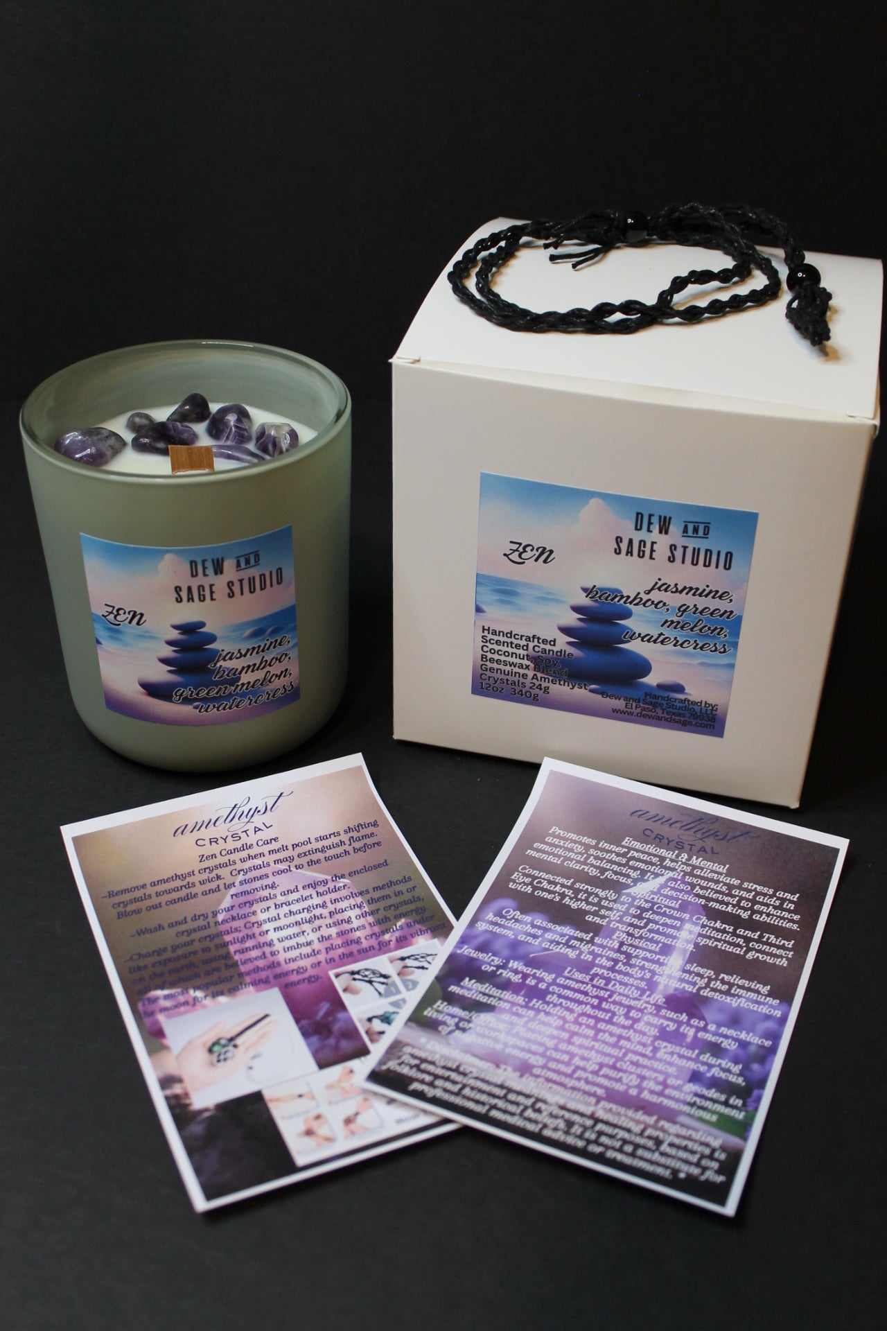 Candle with packaging and cards on a dark surface