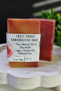 Handcrafted soap bar with a label on a white surface