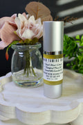 Skincare serum bottle on a wooden tray with flowers in the background