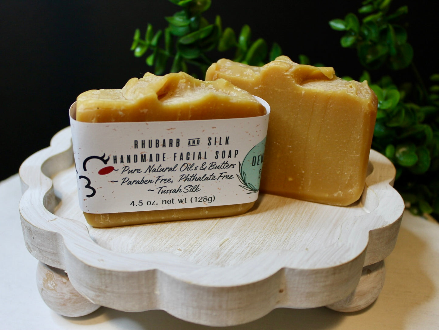 Handmade facial soap on a wooden stand with a dark background