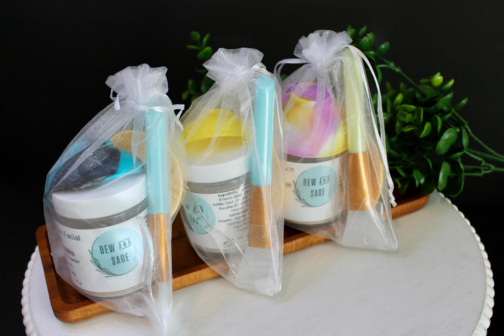 Three skincare products in clear bags on a wooden tray with a dark background