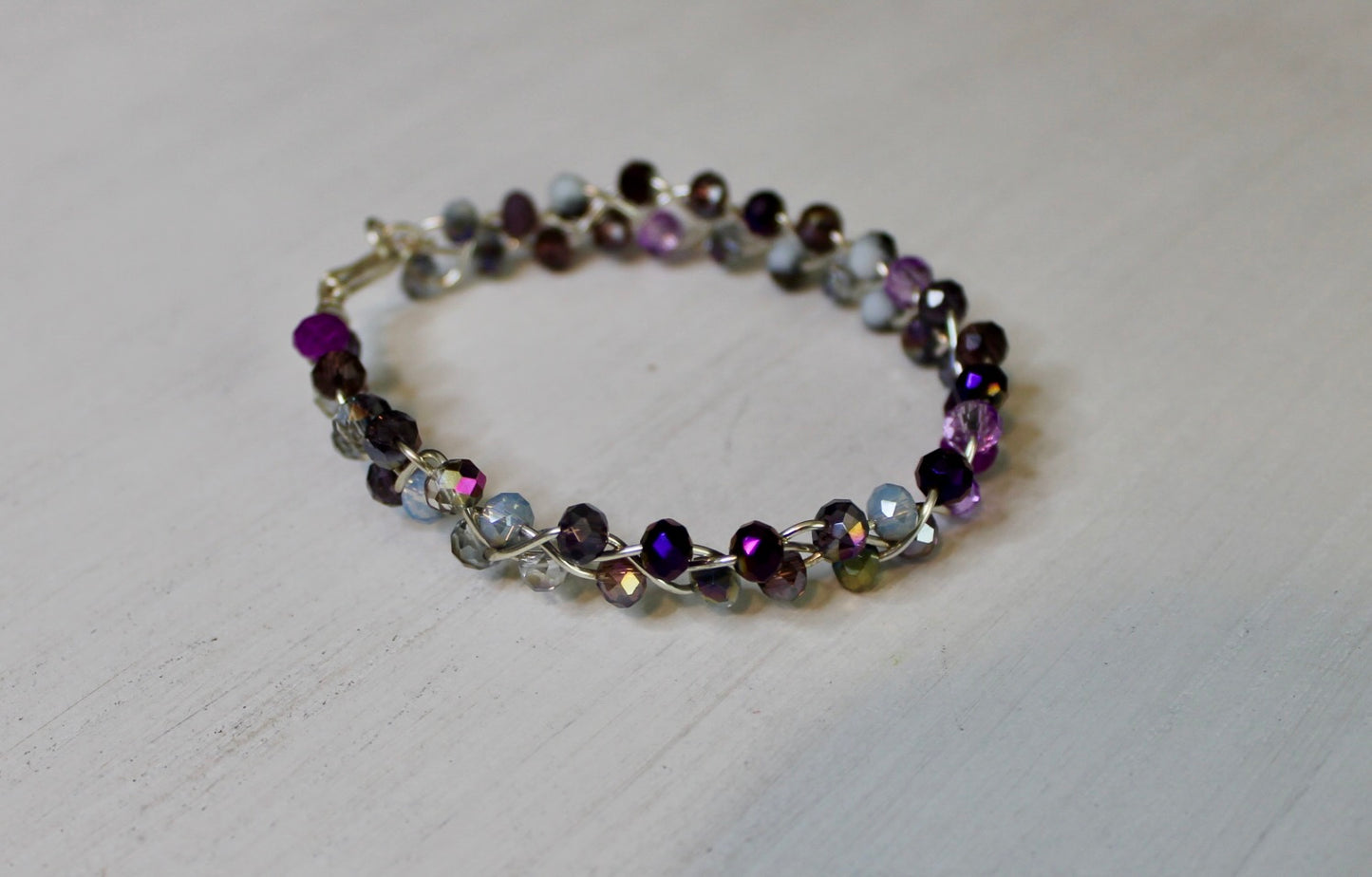 Multicolored beaded bracelet on a light gray surface