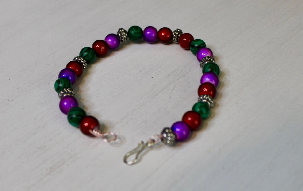 Multicolored beaded bracelet on a light gray background