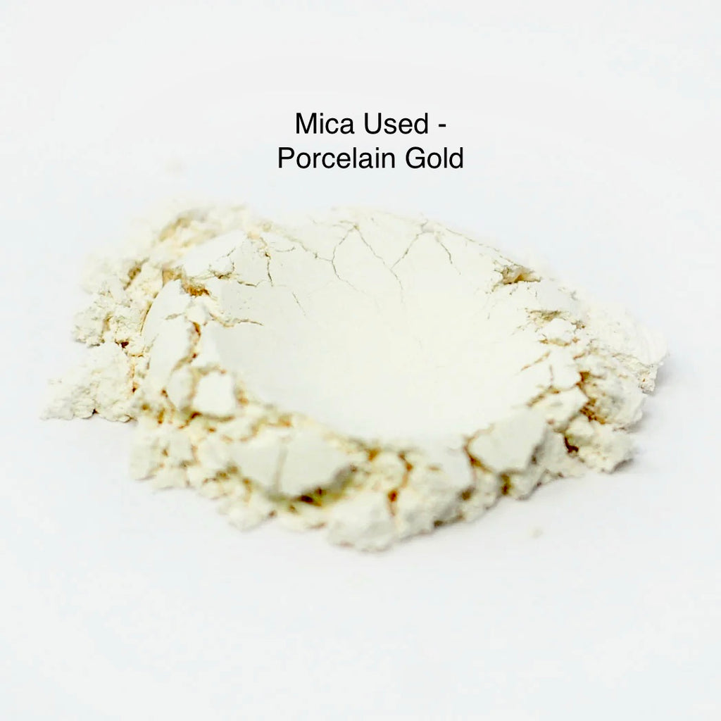 Porcelain gold mica powder on a white background